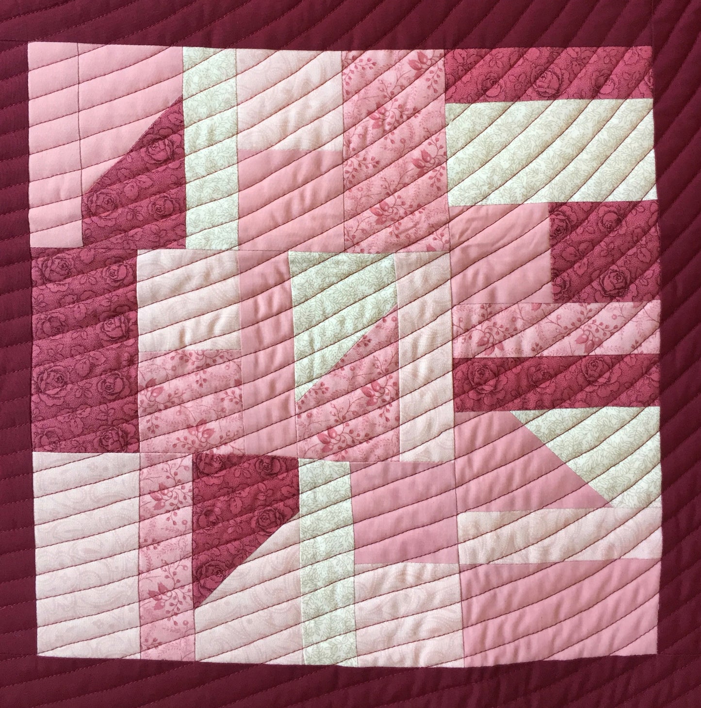 close up of quilt block with random piecing and spiral quilting.