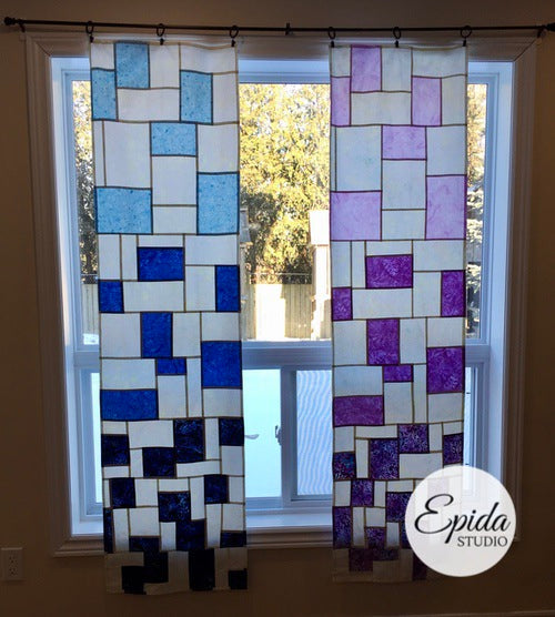 long stained glass window hangings in blue and purple.