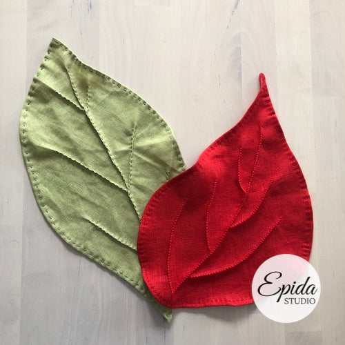Hand-stitched fall leaves in green and red.