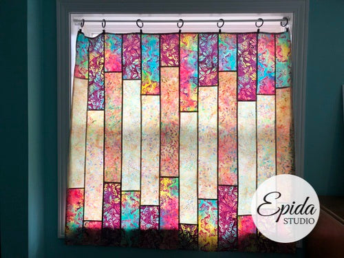 "Glimmer" window hanging made with pink and blue floral batik fabric.