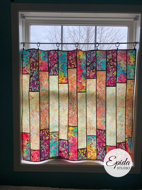 Glimmer stained glass window hanging in pink and blue floral batik fabric.