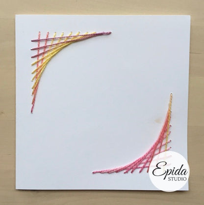 Hand-stitched card with yellow and pink corner design.