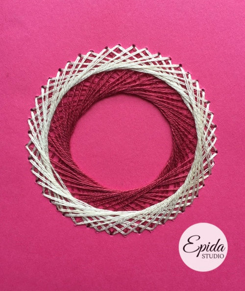 Hand-stitched overlapping circles on greeting card.