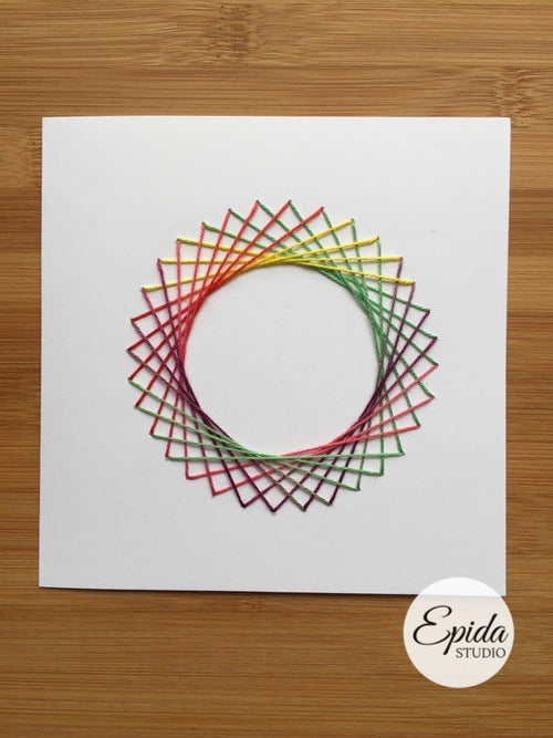 Greeting card with hand-stitched circle design in variegated thread.