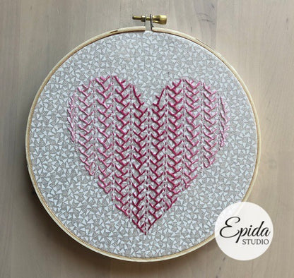 embroidered sampler in heart shape.