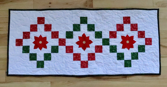 table runner with red and green twist with poinsettia applique.