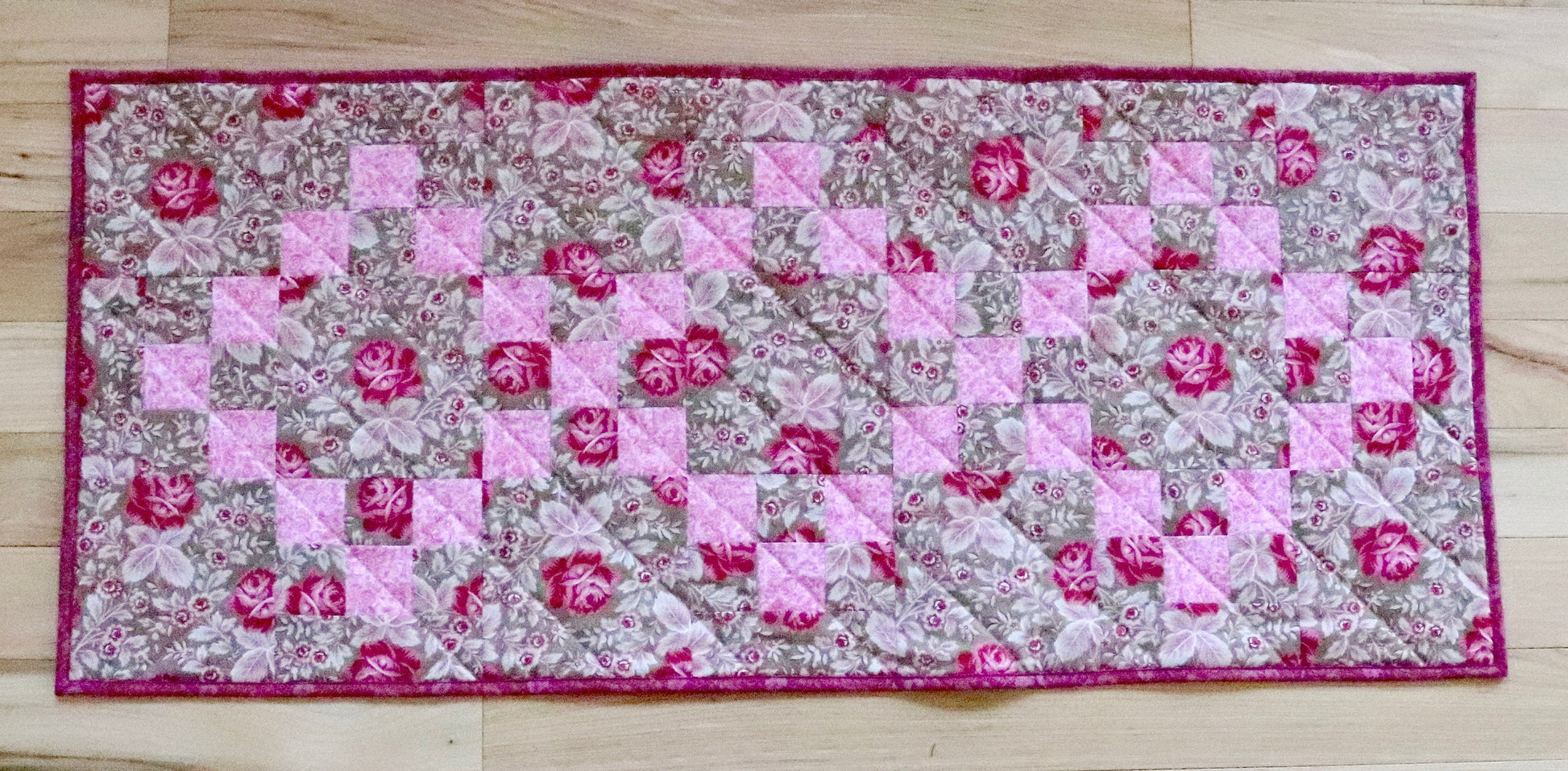 pink floral quilted table runner.
