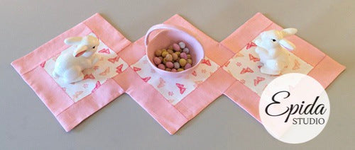 pink hand-stitched table runner.