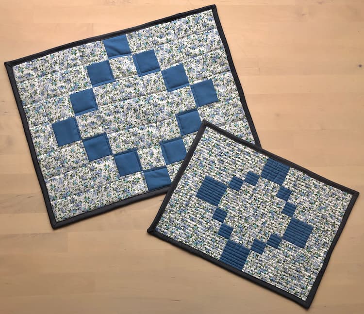 two blue and white quilted placemats.